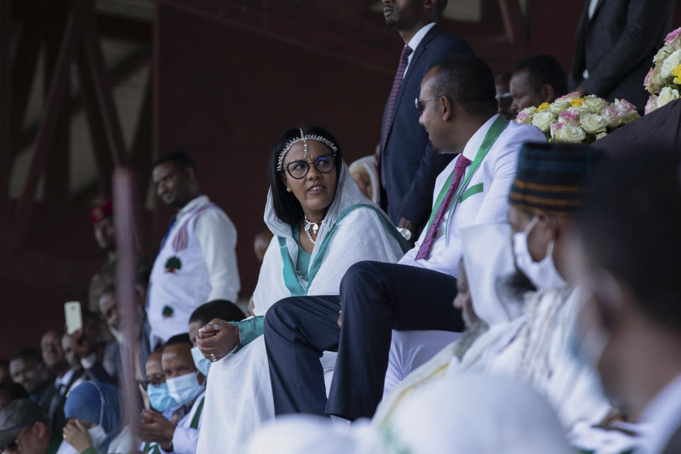 Ethiopia's Prime Minister Abiy Ahmed, center right, speaks to his wife Zinash Tayachew, center left, as they attend a final campaign rally at a stadium in the town of Jimma in the southwestern Oromia Region of Ethiopia Wednesday, June 16, 2021. The country is due to vote in a general election on Monday, June, 21, 2021. (AP Photo/Mulugeta Ayene)