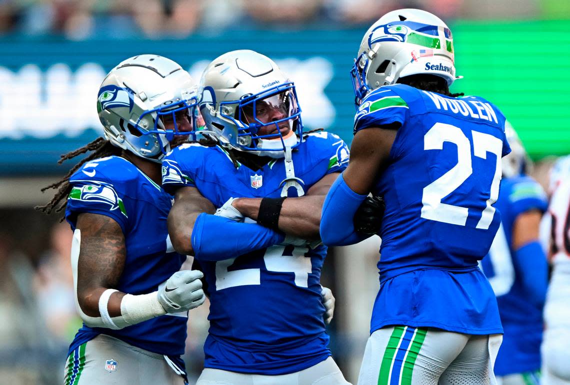 Seattle Seahawks safety K’Von Wallace (24) and cornerback Riq Woolen (27) react to a defensive stop against the Denver Broncos during the third quarter of the game at Lumen Field, on Sunday, Sept. 8, 2024, in Seattle, Wash.