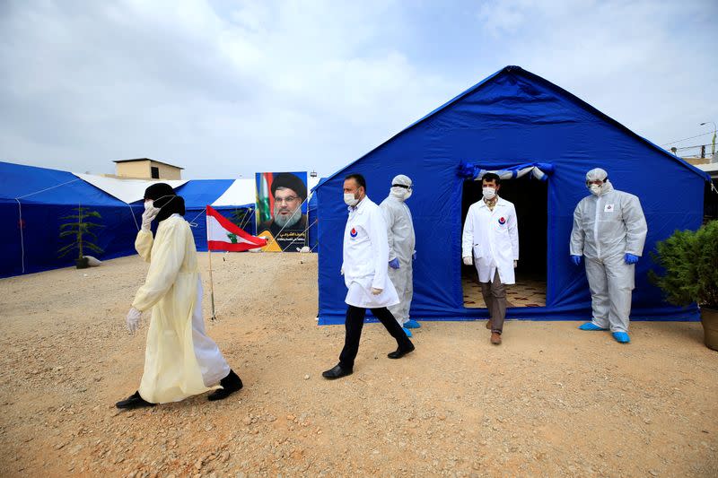 Medics walk outside tent facilities in al-Ghaziyeh