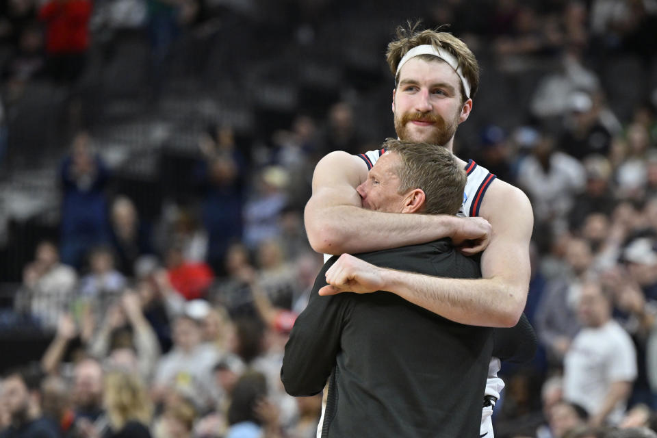 Gonzaga forward Drew Timme hugs head coach Mark Few while checking out of the game during the final minutes in the second half of an Elite 8 college basketball game against UConn in the West Region final of the NCAA Tournament, Saturday, March 25, 2023, in Las Vegas. (AP Photo/David Becker)