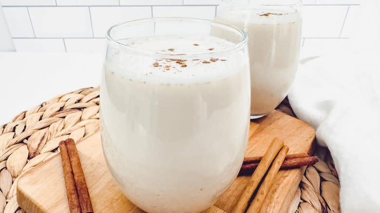 horchata with cinnamon sticks on cutting board