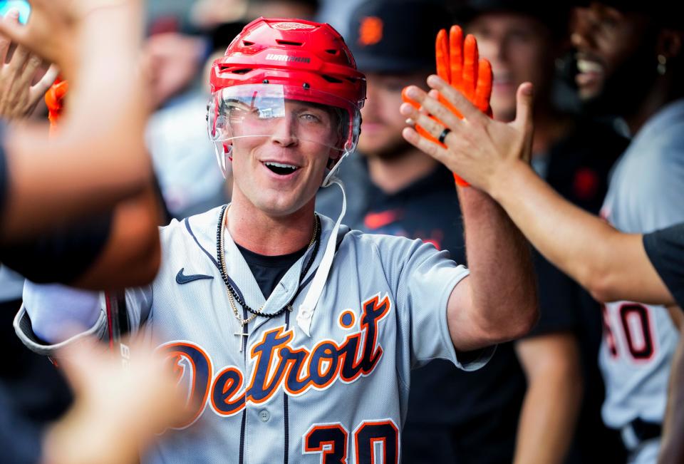 Detroit Tigers' Kerry Carpenter wears a hockey helmet in the dugout after his home run against the Seattle Mariners during the second inning at T-Mobile Park in Seattle on Saturday, July 15, 2023.