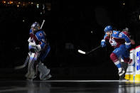 Colorado Avalanche goaltender Darcy Kuemper (35) and left wing Gabriel Landeskog (92) take the ice before Game 1 of the team's NHL hockey Stanley Cup playoffs Western Conference finals against the Edmonton Oilers on Tuesday, May 31, 2022, in Denver. (AP Photo/Jack Dempsey)
