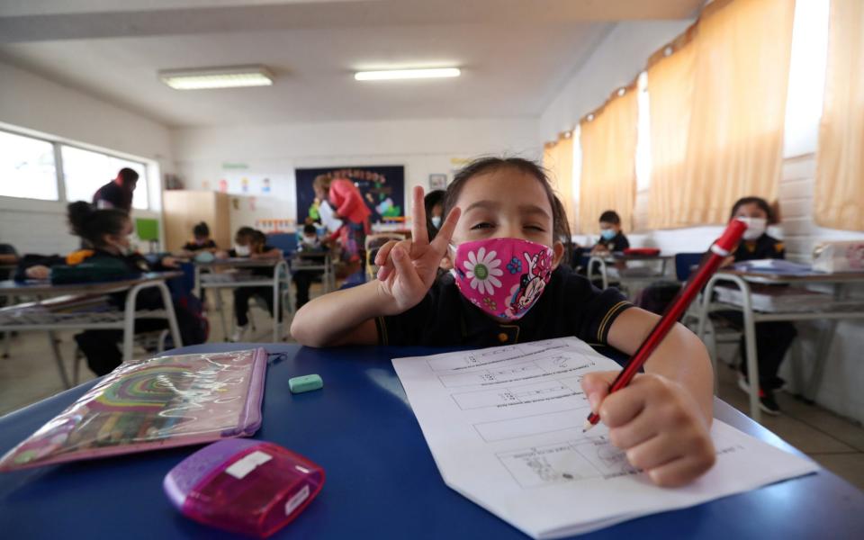 A student gestures inside a classroom at a primary school, as schools reopen in Santiago  - REUTERS/Ivan Alvarado