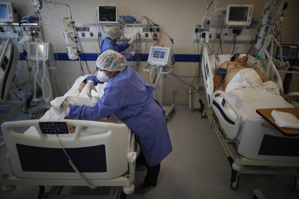 Trabajadores de la salud atienden a un paciente con COVID-19 en el hospital Dr. Norberto Raúl Piacentini en Lomas de Zamora, Argentina, el viernes 23 de abril de 2021, en medio de la pandemia de coronavirus. (AP Foto/Natacha Pisarenko)