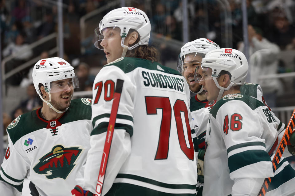 Minnesota Wild left wing Marcus Johansson, left, center Oskar Sundqvist, center Frederick Gaudreau, right rear, and Jared Spurgeon (46) celebrate Gaudreau's goal during the second period of an NHL hockey game against San Jose Sharks in San Jose, Calif., Saturday, March 11, 2023. (AP Photo/Josie Lepe)