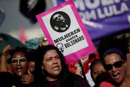 A woman holds a sign that reads "Women against Bolsonaro" during demonstrations against presidential candidate Jair Bolsonaro in Brasilia, Brazil September 29, 2018. REUTERS/Adriano Machado