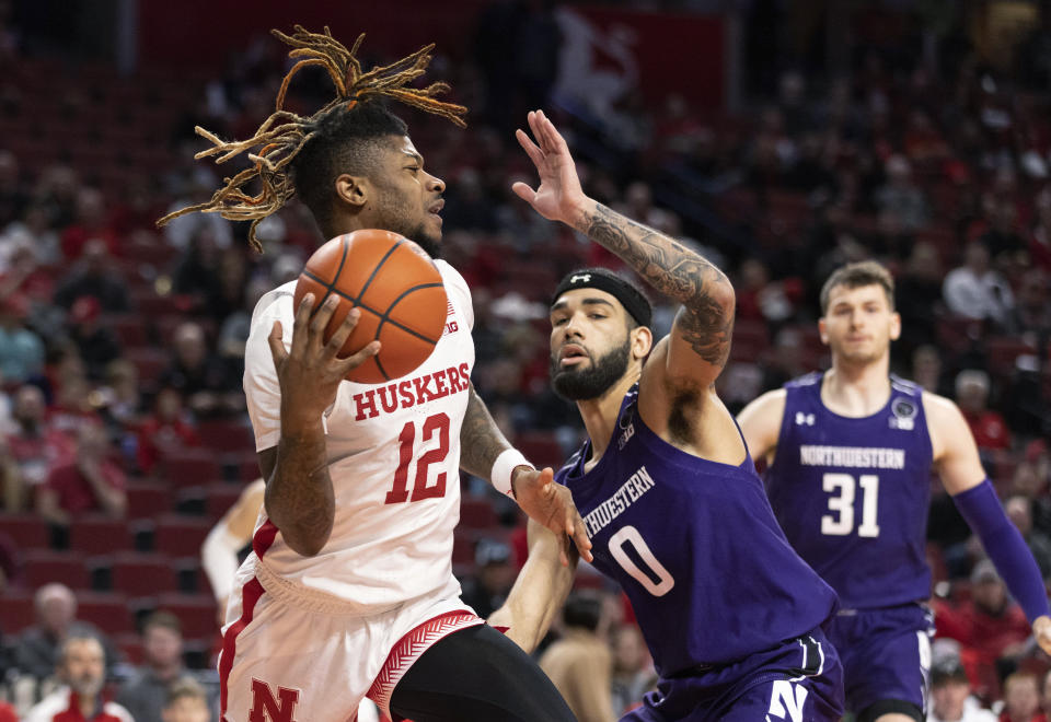 Nebraska's Denim Dawson (12) is defended by Northwestern's Boo Buie (0) during the first half of an NCAA college basketball game Wednesday, Jan. 25, 2023, in Lincoln, Neb. (AP Photo/Rebecca S. Gratz)