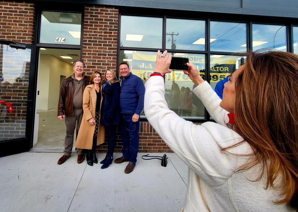 Congresswoman Lisa McClain takes a photo of Tom and Kathy Vertin, left, and Chris and Lyniene LaBelle on Monday, Nov. 20, 2023, outside the newly completed Marine City Manor.