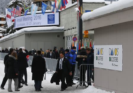 Attendees walk outside the Congress Center during the Annual Meeting 2016 of the World Economic Forum (WEF) in Davos, Switzerland January 20, 2016. REUTERS/Ruben Sprich