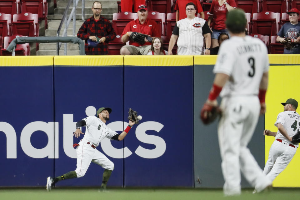 A number of Reds players and Carlos Gonzalez forgot how to play baseball for one play. (AP)