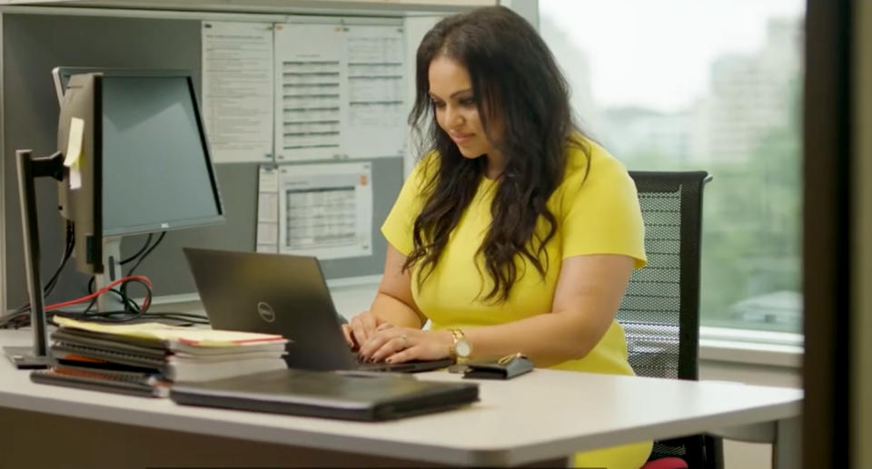 Miriam at her desk in her office.