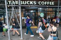 Starbucks workers attend a protest as part of a collective action over a Pride decor dispute, outside a Starbucks shop