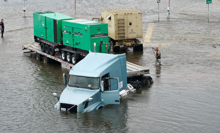 A truck carrying generators is stuck in Hurricane Harvey floodwaters near Alvin, Texas August 29, 2017. REUTERS/Rick Wilking