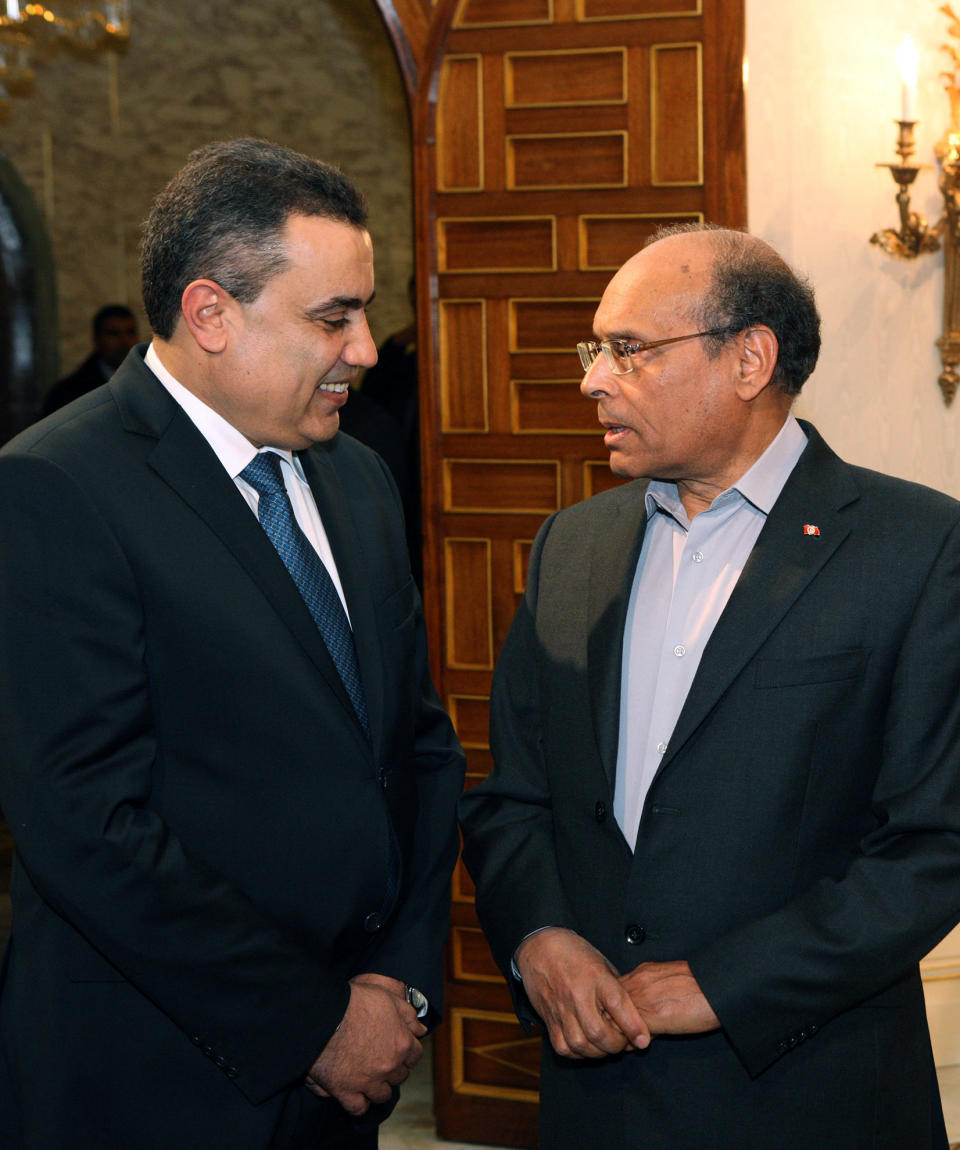 Tunisian President Moncef Marzouki, right, greets newly appointed Prime Minister Mehdi Jemaa, at Carthage Palace, in Tunis, Tunisia, Saturday, Jan. 25, 2014. The Tunisian opposition threatened Saturday to vote against the draft constitution if the incoming prime minister decides to keep the current interior minister in his cabinet. (AP Photo/Hassene Dridi)