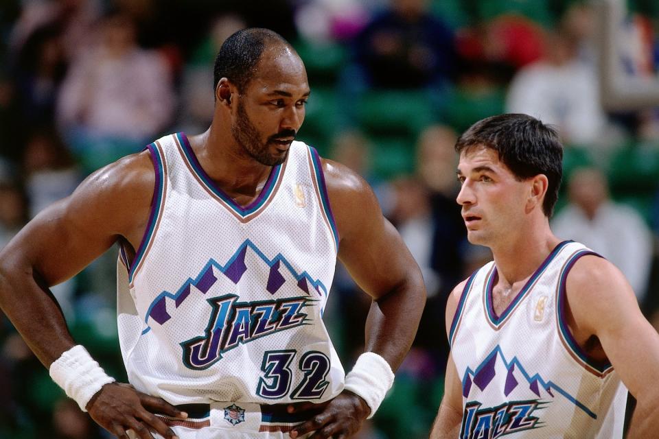 Karl Malone and John Stockton of the Utah Jazz pause during a break in NBA game action at the Delta Center circa 1997 in Salt Lake City, Utah.