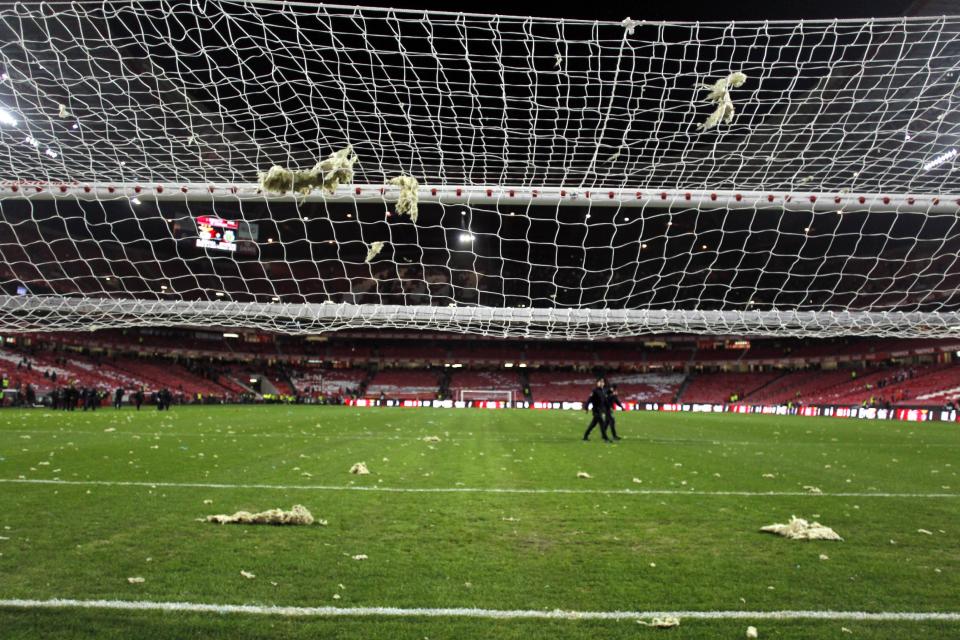 Pieces of debris fallen from the roof of the stadium rest over the pitch and the goal's net, prior the Portuguese league soccer match between Benfica and Sporting at Benfica's Luz stadium, in Lisbon, Sunday, Feb. 9, 2014. Strong winds damaged the stadium roof before kick off and debris fell on the pitch and stands. It was decided the match should be postponed for security reasons. (AP Photo/Francisco Seco)