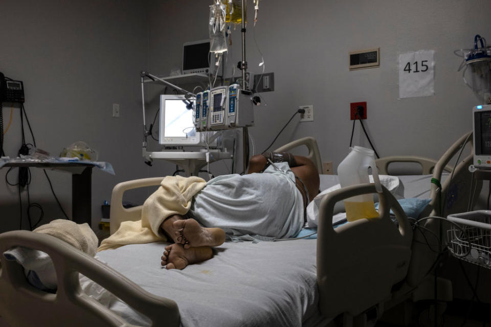 A patient is seen lying on a bed in the Covid-19 intensive care unit (ICU) on New Year's Day at the United Memorial Medical Center in Houston, Texas. 