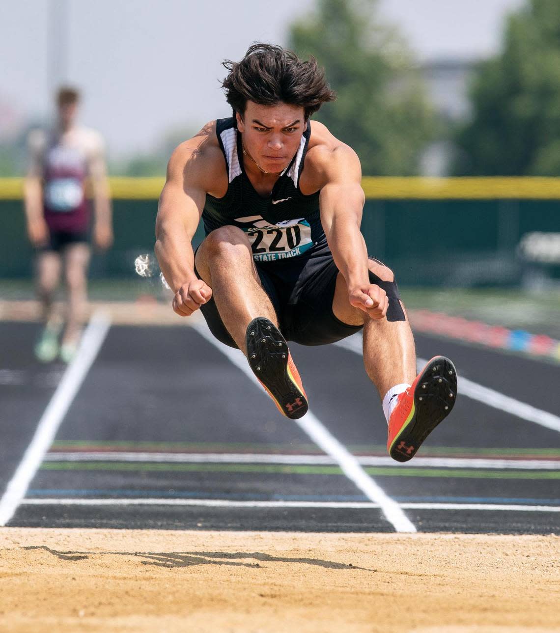 Eagle’s Makeo Sneddon competes in the long jump at the 5A state track meet.