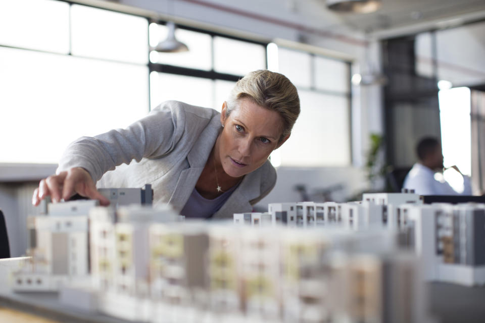 A woman inspecting an architectural model