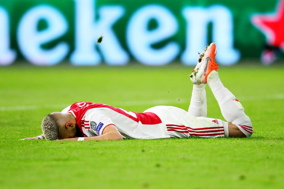 Ziyech is left deflated in the turf as the referee blows for full-time.