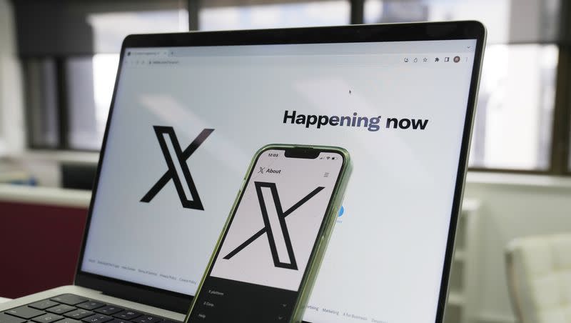 The opening page of X is displayed on a computer and phone in Sydney, Monday, Oct. 16, 2023. 