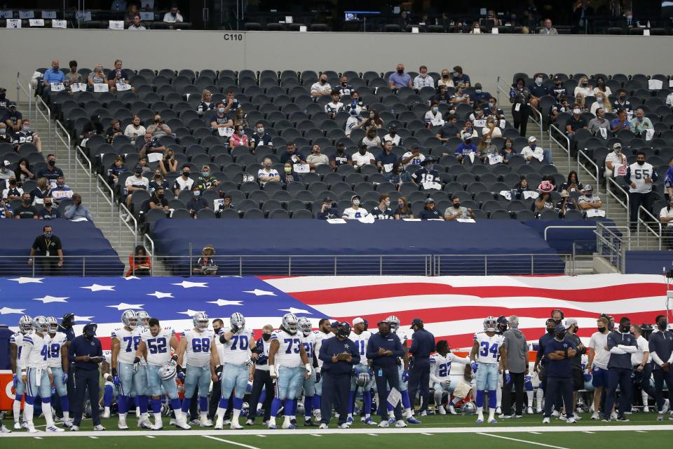 Socially distanced fans look on fro the lower bowl at AT&T Stadium as the Dallas Cowboys play the Atlanta Falcons in the first half of an NFL football game in Arlington, Texas, Sunday, Sept. 20, 2020. (AP Photo/Michael Ainsworth)