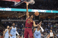 Cleveland Cavaliers Jarrett Allen (31) dinks while defended by Memphis Grizzlies guard Ja Morant (12) during the first half of an NBA basketball game Wednesday, Oct. 20, 2021, in Memphis, Tenn. (AP Photo/Nikki Boertman)