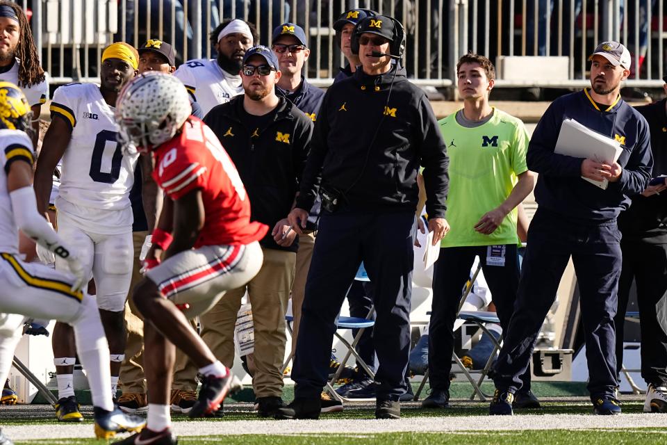 Michigan coach Jim Harbaugh watches from the sideline beside off-field analyst Connor Stalions in a game at Ohio State on Nov. 26, 2022.