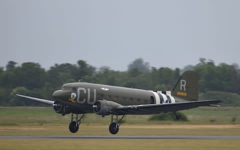 A Douglas C-53 named D-Day Doll takes off from the runway at the Imperial War Museum Duxford  - Credit: Joe Giddens/PA