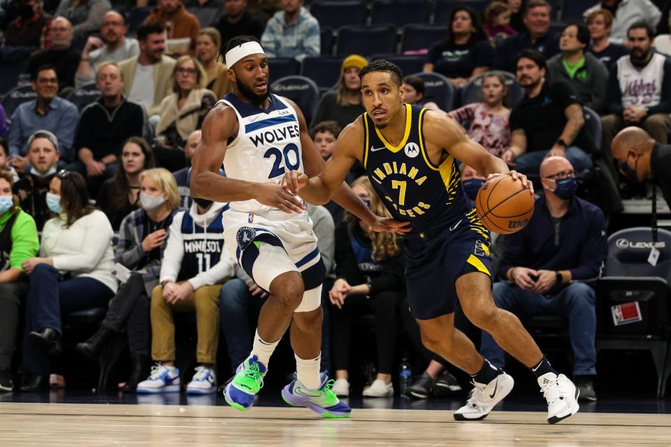 Nov 29, 2021; Minneapolis, Minnesota, USA; Indiana Pacers guard Malcolm Brogdon (7) drives to the basket while Minnesota Timberwolves forward Josh Okogie (20) defends in the first quarter at Target Center.