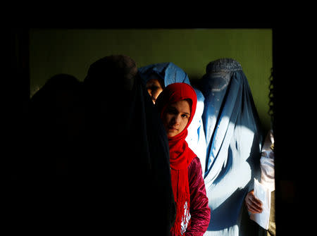 Afghan women line up to cast their votes during a parliamentary election at a polling station in Kabul, Afghanistan, October 20, 2018. REUTERS/Omar Sobhani