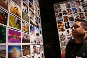 Man staring at panel of Flickr images