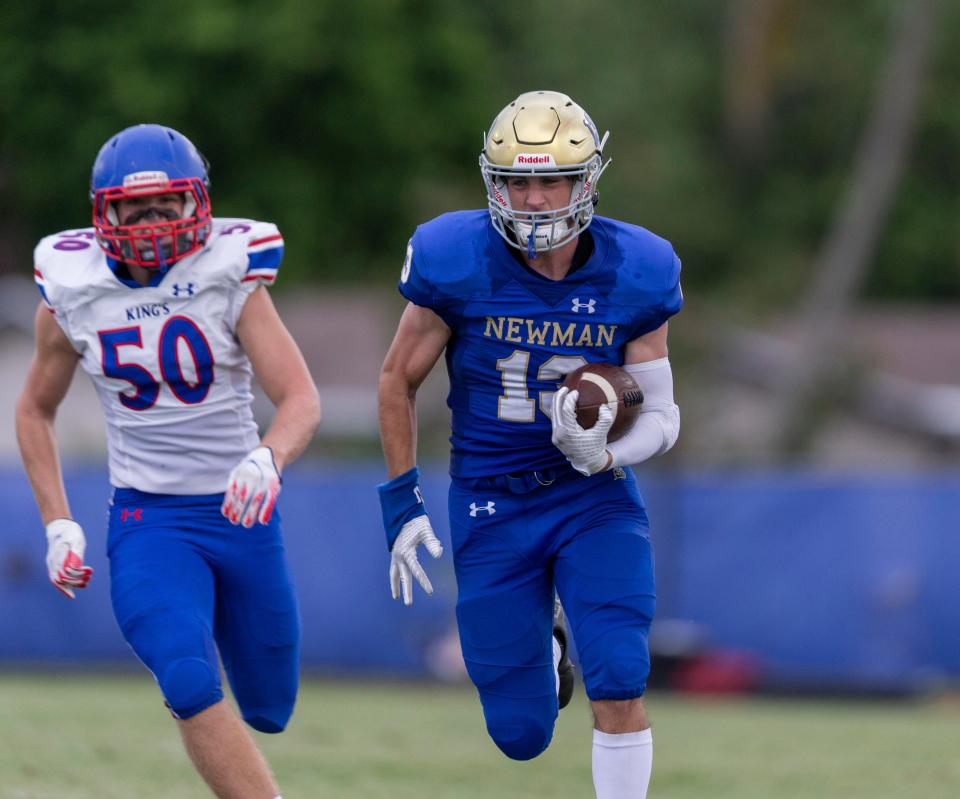 Cardinal Newman Chris Presto takes off for the endzone and make the first score against King's Academy in West Palm Beach, Florida on August 27, 2021. 