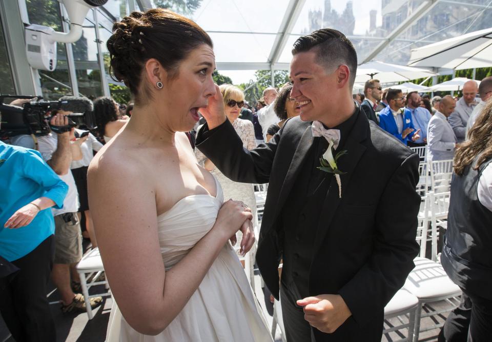 Murphy and St. Germain celebrate after the ceremony for "The Celebration of Love", a grand wedding where over 100 LGBT couples got married, at Casa Loma in Toronto