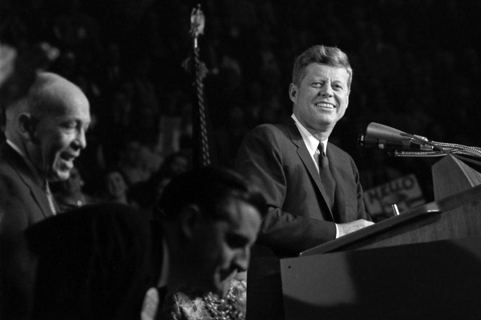 <p>John F. Kennedy addresses the Bean Feed at the Hippodrome in St. Paul, Minn., Oct. 6, 1962. In the foreground are State Democratic Chairman George Farr and Minnesota Attorney General Walter F. Mondale. (Photo: Cecil Stoughton/John F. Kennedy Presidential Library and Museum) </p>