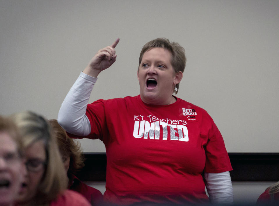 Kristin Walker, a Jefferson County teacher shouts in a hearing room to protest a bill that would change how individuals are nominated to the Kentucky teachers retirement systems board of trustees, in Frankfort,, Ky, Thursday, Feb 28, 2019. (AP Photo/Bryan Woolston)