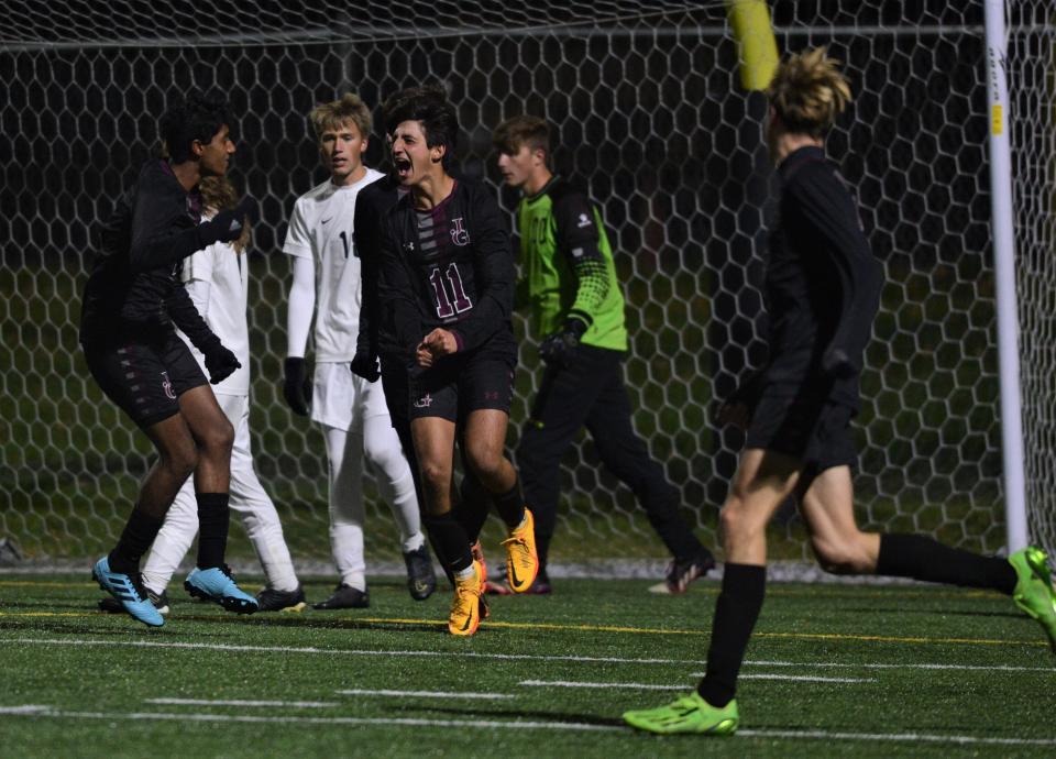 John Glenn's Will Nicolozakes celebrates his go-ahead goal with his teammates in a 3-1 win over Tri-Valley in the Division II sectional final on Tuesday.