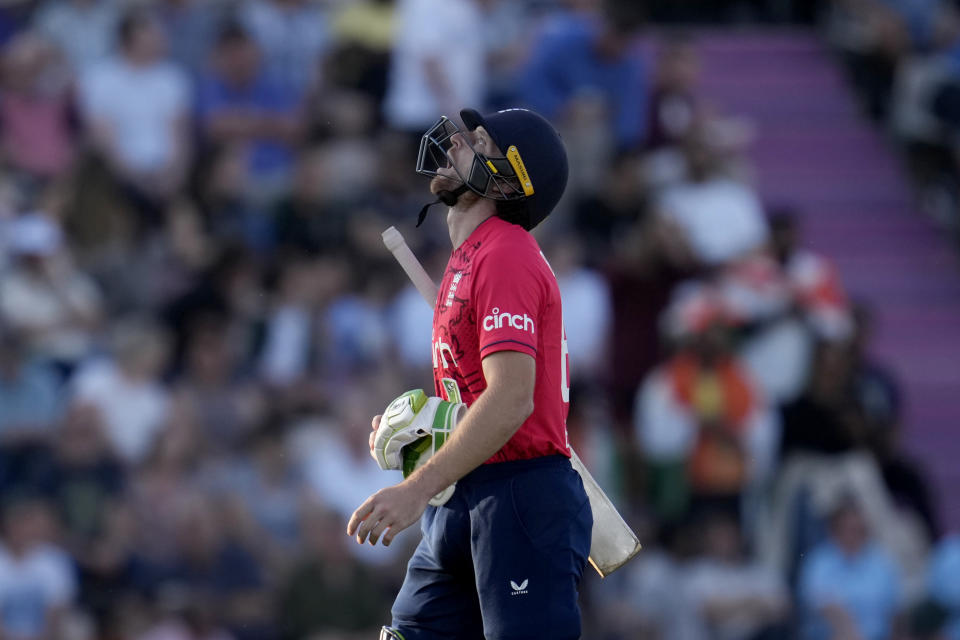 England captain Jos Buttler walks off the field of play after losing his wicket from the bowling of India's Bhuvneshwar Kumar during the first T20 international cricket match between England and India at The Ageas Bowl in Southampton, England, Thursday, July 7, 2022. (AP Photo/Matt Dunham)