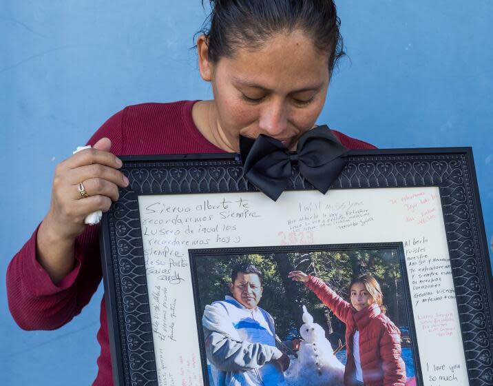 Anaheim, CA - April 10: Erika Lopez, shown holding a photo of her late husband, Alberto Lopez, 36, left, and 10 year old daughter, Lucero Lopez, at her apartment in Anaheim Wednesday, April 10, 2024. Lopez, who was 9 months pregnant when the church van she was riding in was struck by a DUI driver. Erika's 10 year old daughter and her husband died in the crash. The driver, Mario Armando Paz Jr., is awaiting trial on manslaughter charges. Lopez is speaking out against prosecutors potentially giving Paz a plea deal that would significantly reduce his possible prison sentence. Her daughter who died in the crash is 10 year old Lucero Lopez. Her husband's name is Alberto Lopez, 36. (Allen J. Schaben / Los Angeles Times)