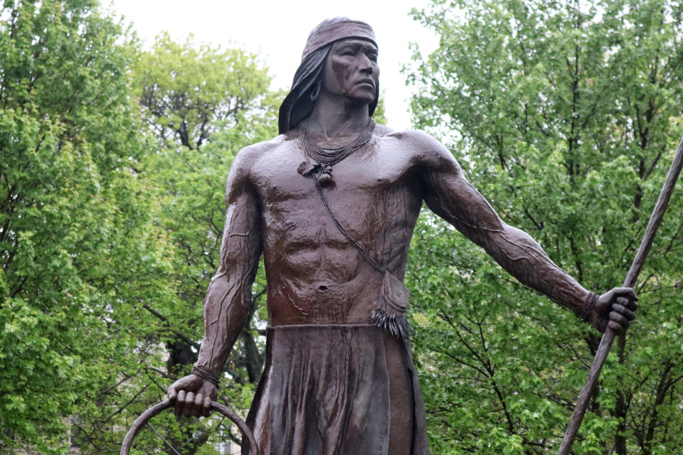 A bronze statue by Craig Goseyun depicts an Apache hoop and pole game player. The statue, erected in 1997, is on the campus at Haskell Indian Nations University at Lawrence, Kansas. 