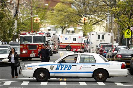 NYPD officers stand near the scene of a derailed F train in Woodside, New York, May 2, 2014. REUTERS/Eduardo Munoz