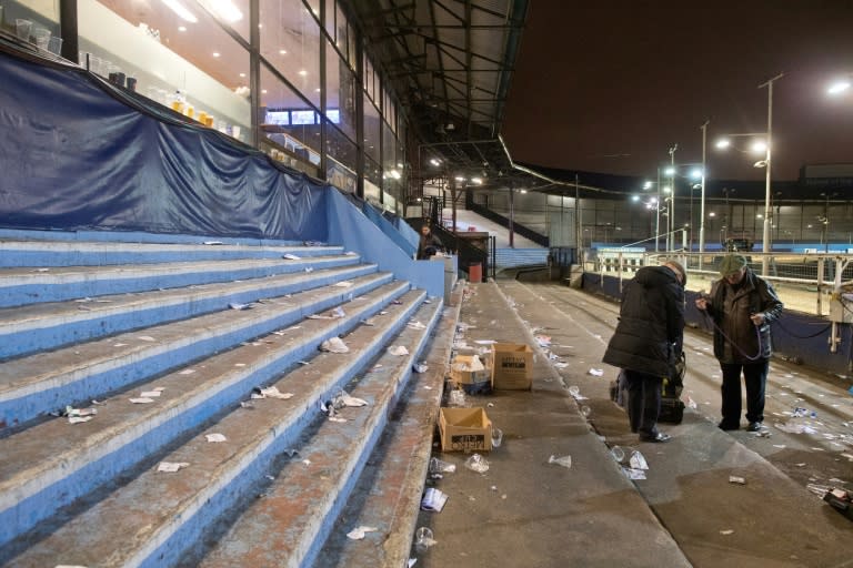 Book makers pack away their belongings after an evening of greyhound racing at the Wimbledon Stadium dog track in south London