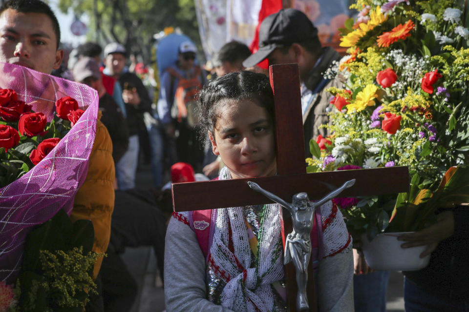 Devotees of the Virgin of Guadalupe walk to the Basilica to give thanks or worship a day before her national celebration in Mexico City, on Sunday, Dec. 11, 2022. (AP Photo/Ginnette Riquelme)