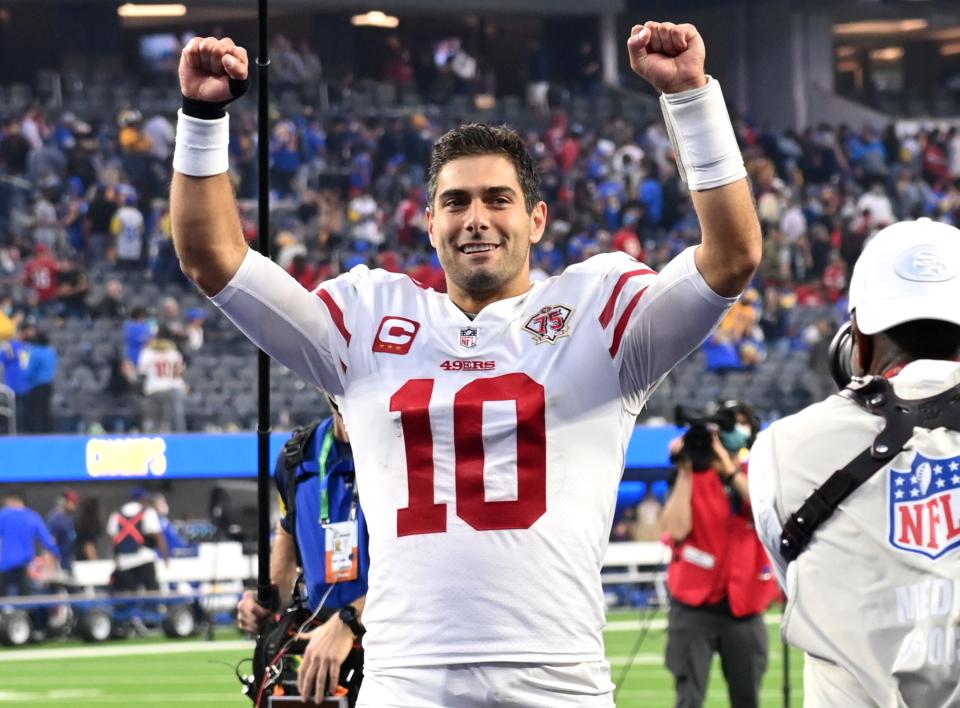 San Francisco 49ers quarterback Jimmy Garoppolo (10) celebrates as he leaves the field after defeating the Los Angeles Rams in the overtime period of the game at SoFi Stadium.