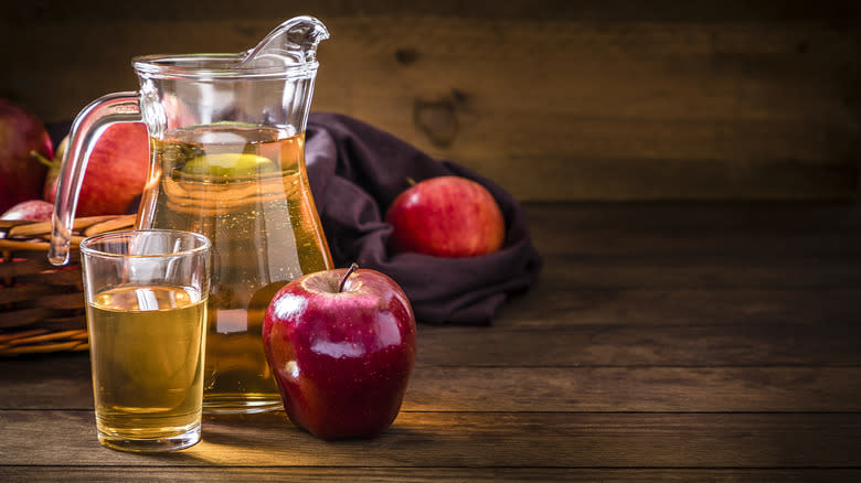 Jug of apple juice and apples