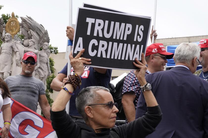 Protesters gather near the E. Barrett Prettyman U.S. Federal Courthouse, Thursday, Aug. 3, 2023, in Washington. (AP Photo/Mariam Zuhaib)