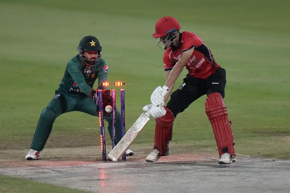 Hong Kong's Aizaz Khan looks bails shattered by Pakistan's Shadab Khan during the T20 cricket match of Asia Cup between Pakistan and Hong Kong, in Sharjah, United Arab Emirates, Friday, Sept. 2, 2022. (AP Photo/Anjum Naveed)