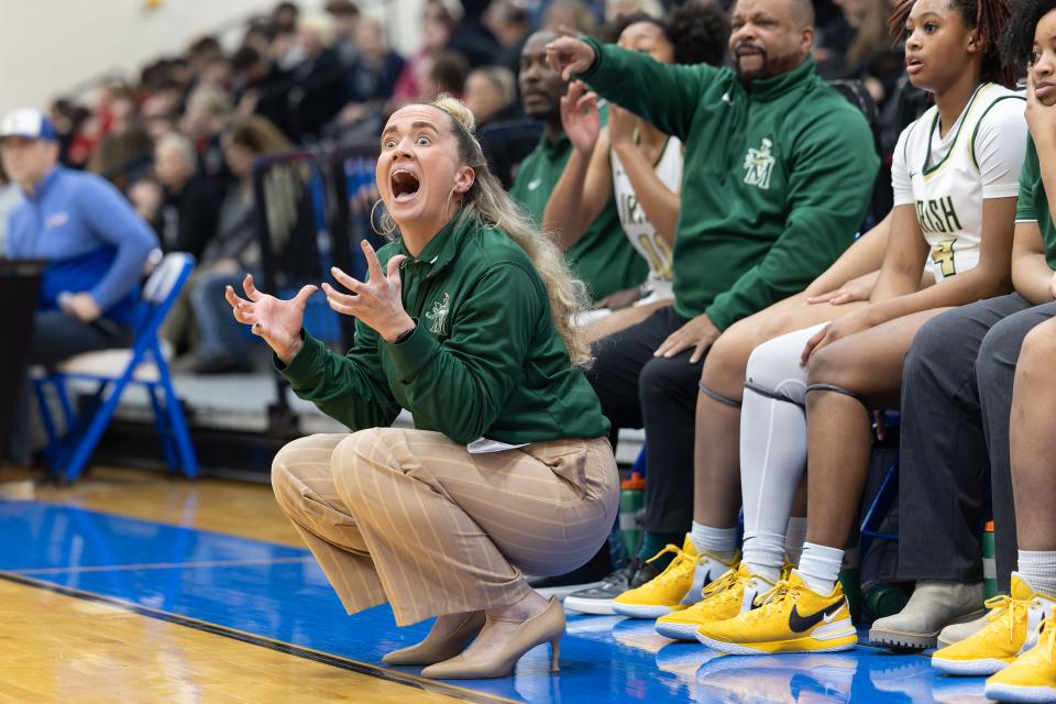 St. Vincent-St. Mary girls basketball coach Carley Whitney reacts to a call during a district final March 2 at Lake High School.