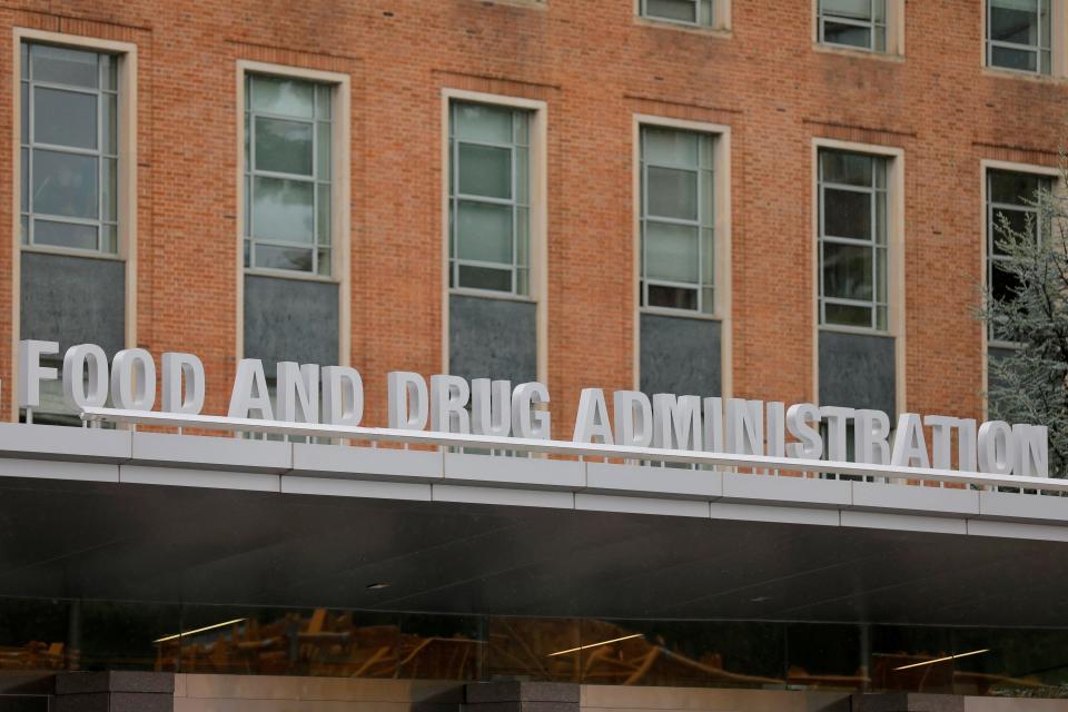 Metal lettering that reads "Food and Drug Administration" sits on a roof against a brick background at the FDA's headquarters in White Oak, Maryland.